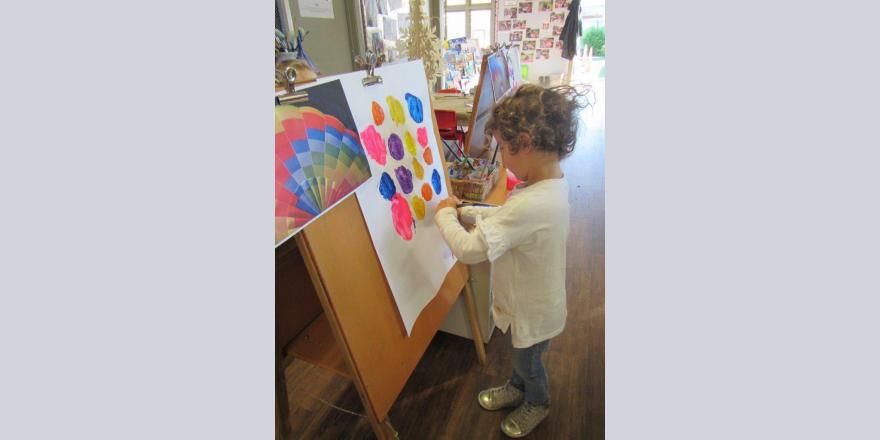 Girl painting at kindergarten