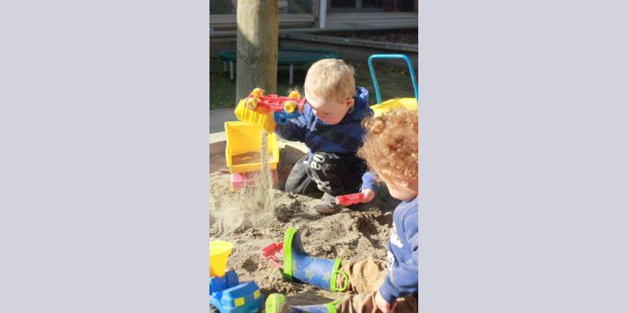 Two kids playing in the sandpit at Annabel's Avonhead preschool