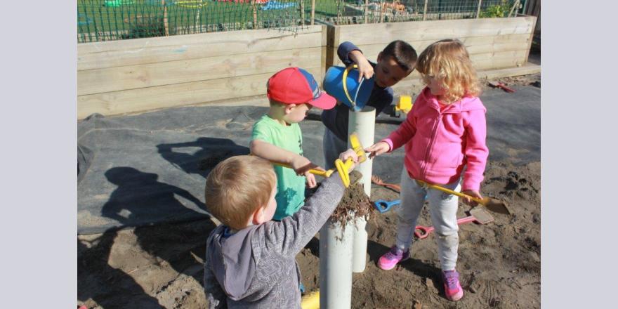 Children at Annabel's Avonhead preschool building sand structures in the sandpit 
